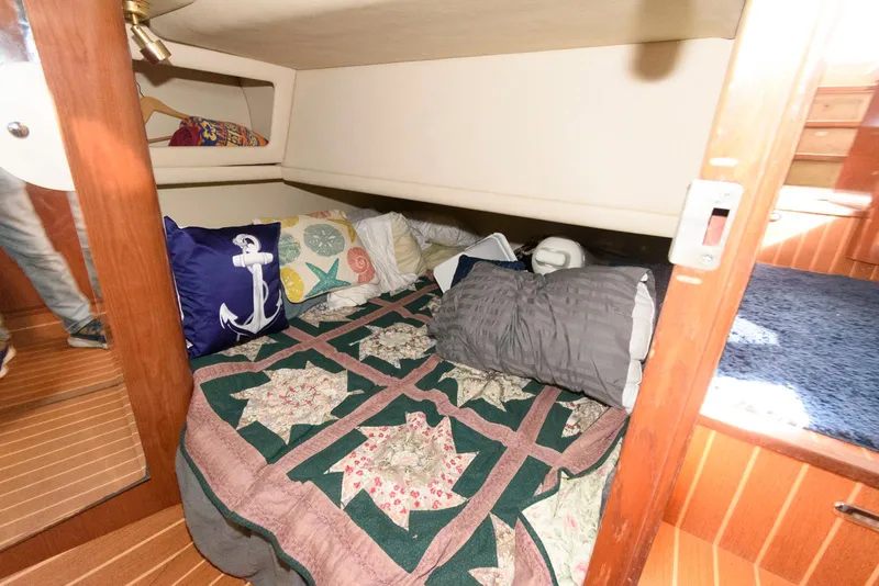 Slide: The Image of Cozy cabin interior of 2002 Sea Ray 480 Motor Yacht with nautical-themed bedding. - 24