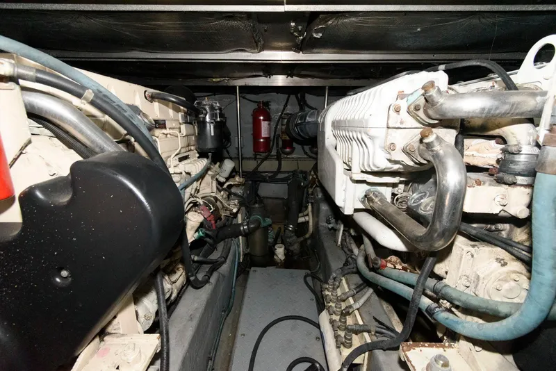 Slide: The Image of Engine room of 2002 Sea Ray 480 Motor Yacht, showcasing mechanical components and piping. - 25