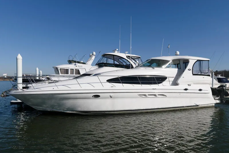 Slide: The Image of 2002 Sea Ray 480 Motor Yacht docked on calm water under clear blue sky. - 4