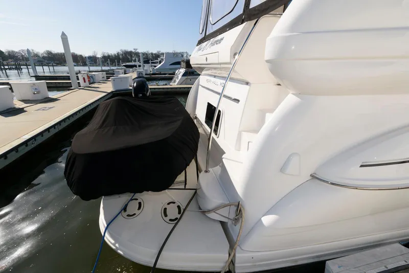 Slide: The Image of 2002 Sea Ray 480 Motor Yacht docked, rear view with covered equipment. - 5