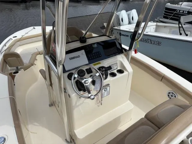 Slide: The Image of 2022 Scout 215 XSF boat interior with steering console and seating. - 10
