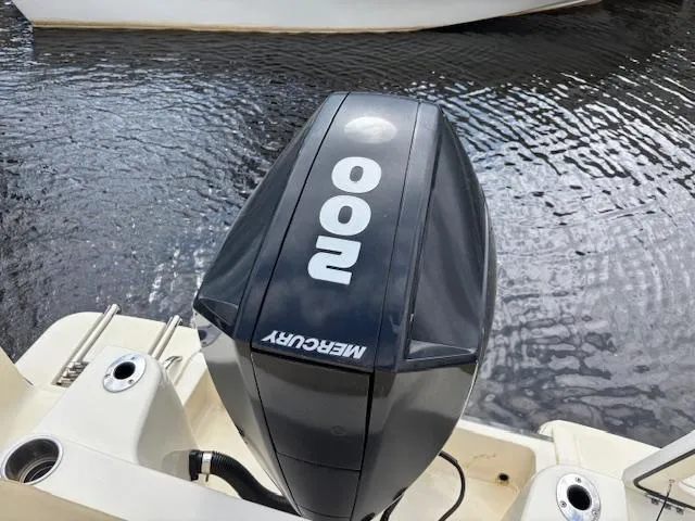 Slide: The Image of 2022 Scout 215 XSF boat with Mercury 200 outboard motor on water. - 11