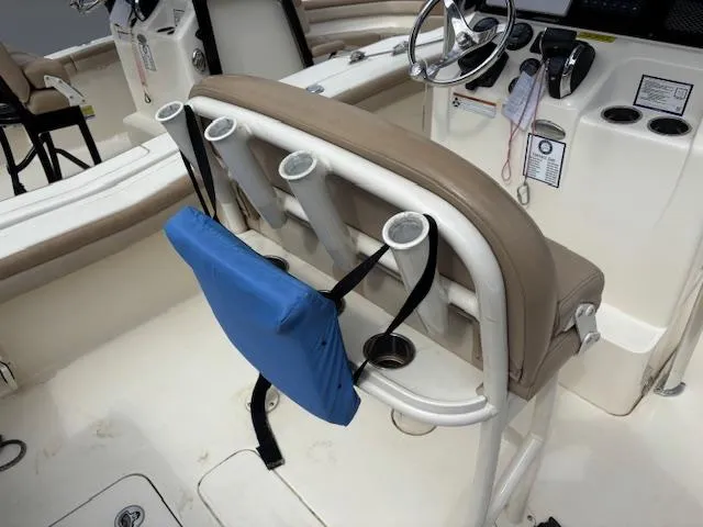 Slide: The Image of 2022 Scout 215 XSF boat interior with rod holders and steering console. - 13