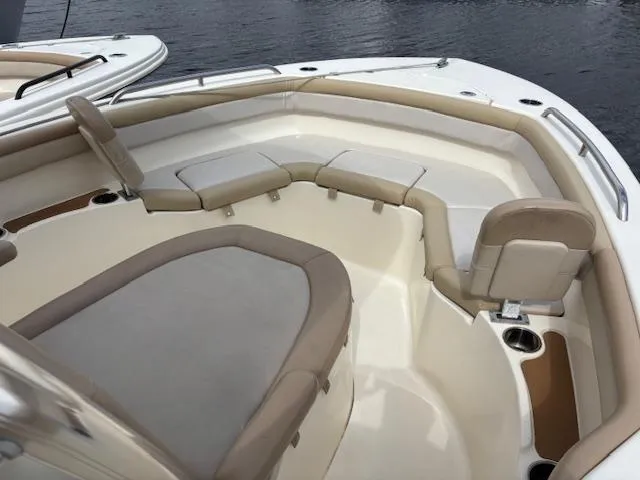 Slide: The Image of 2022 Scout 215 XSF boat interior with beige seating and cup holders. - 14