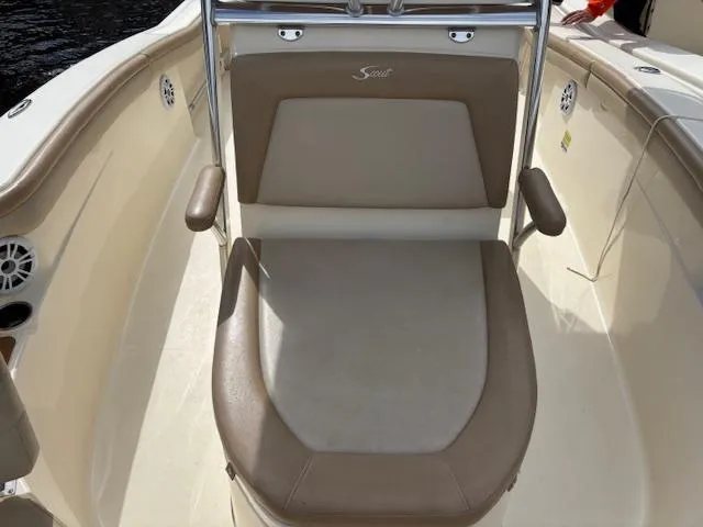Slide: The Image of 2022 Scout 215 XSF boat seat with beige upholstery and armrests. - 15