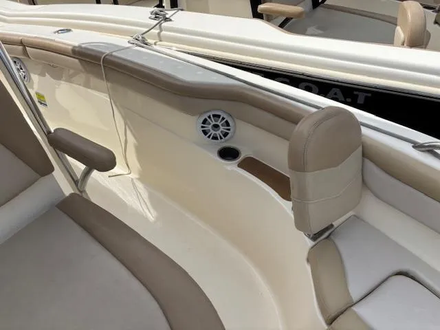 Slide: The Image of 2022 Scout 215 XSF boat interior with beige seating and speaker. - 16