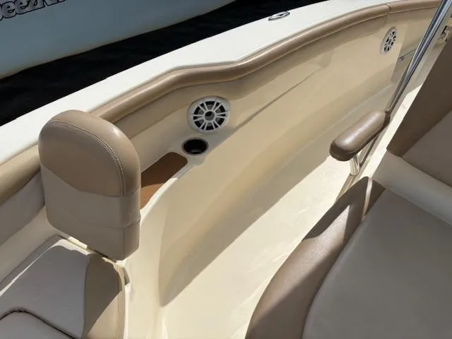 Slide: The Image of 2022 Scout 215 XSF boat interior with beige seating and speaker detail. - 17