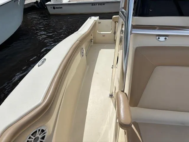 Slide: The Image of 2022 Scout 215 XSF boat interior with beige seating and sleek design. - 18