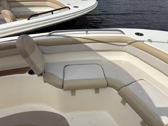 Slide: The Image of 2022 Scout 215 XSF boat interior with beige seating, on calm water. - 21