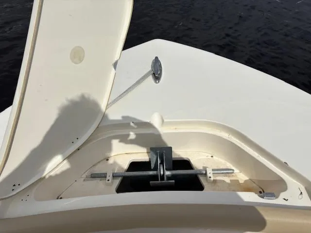 Slide: The Image of Open anchor compartment on 2022 Scout 215 XSF boat, showing anchor storage. - 23