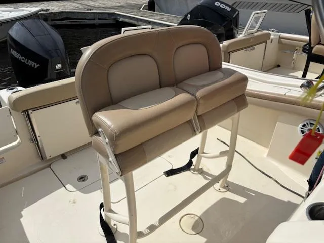 Slide: The Image of 2022 Scout 215 XSF boat interior with tan seating and Mercury outboard motor. - 24