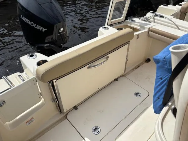 Slide: The Image of 2022 Scout 215 XSF boat interior with Mercury engine, featuring seating and storage. - 25