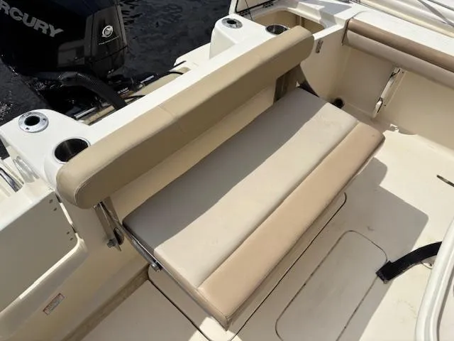 Slide: The Image of 2022 Scout 215 XSF boat interior with beige seating and cup holders. - 26