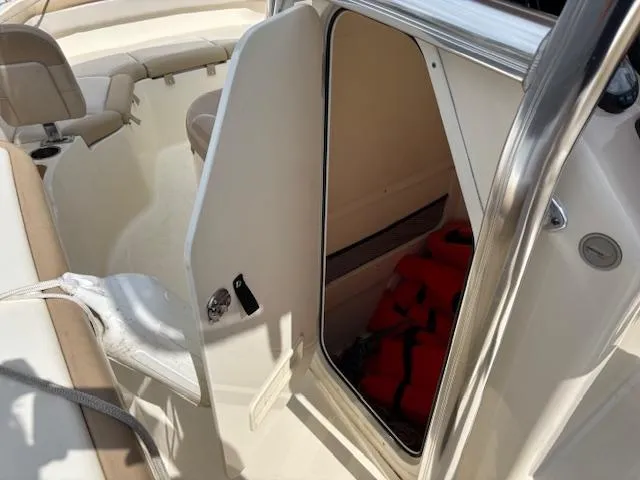 Slide: The Image of 2022 Scout 215 XSF boat interior with open storage compartment and seating area. - 33