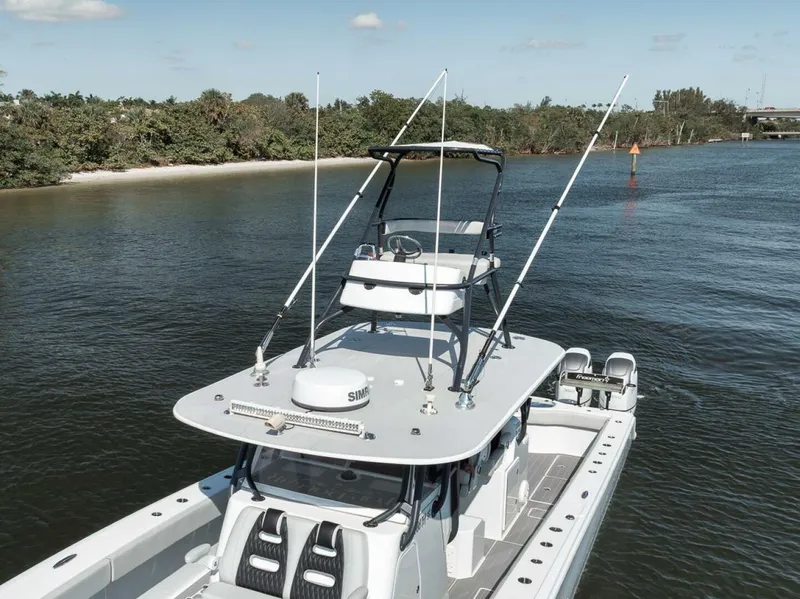 Slide: The Image of 2019 Freeman 42LR boat on calm water near a forested shoreline. - 11