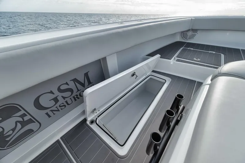 Slide: The Image of Freeman 42LR 2019 boat interior with storage compartment and rod holders. - 15