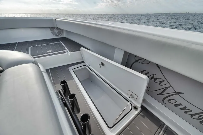 Slide: The Image of 2019 Freeman 42LR boat interior with open storage compartment and rod holders. - 16