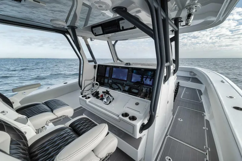 Slide: The Image of 2019 Freeman 42LR boat interior with advanced navigation system and luxurious seating on open water. - 21