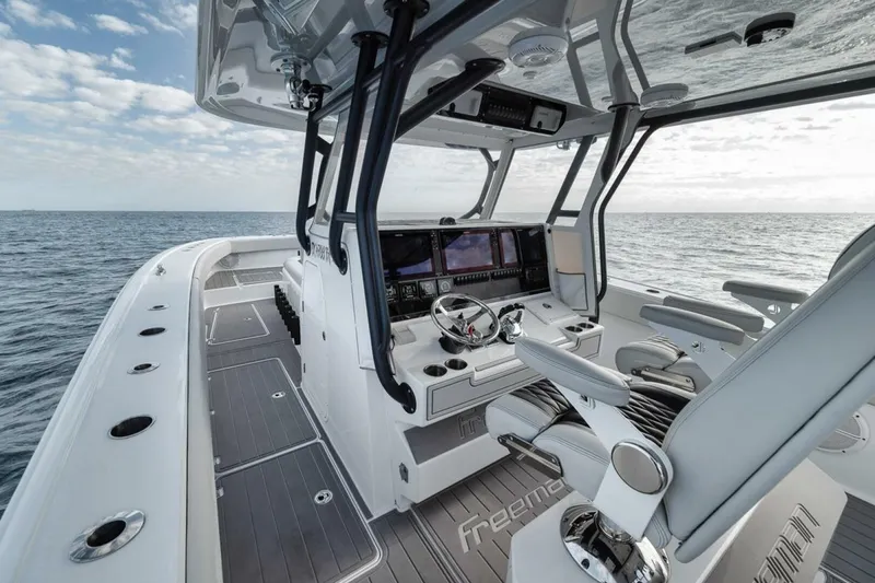 Slide: The Image of 2019 Freeman 42LR boat interior with modern helm, ocean view, and sleek design. - 24