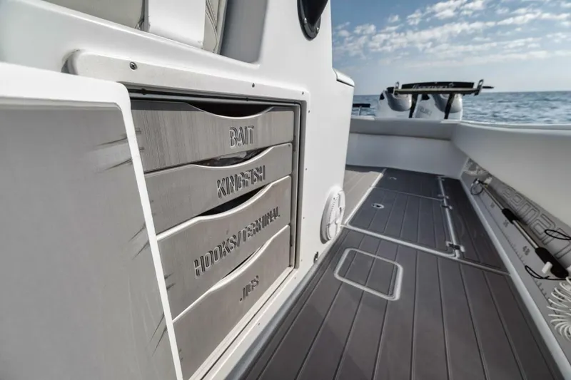 Slide: The Image of 2019 Freeman 42LR boat deck with storage compartments, ocean view, and clear sky. - 25