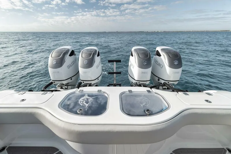 Slide: The Image of Four Suzuki outboard motors on a 2019 Freeman 42LR boat, ocean view. - 28