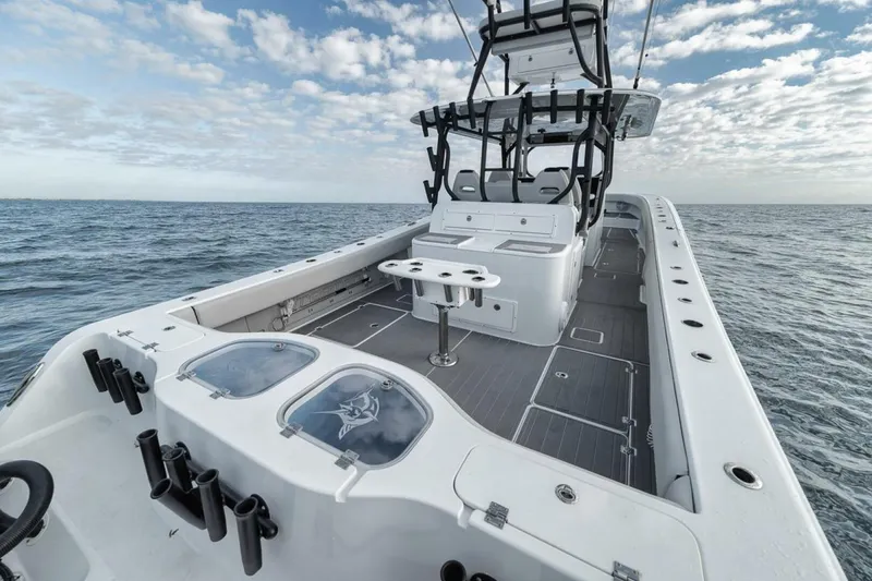 Slide: The Image of 2019 Freeman 42LR boat on open water, featuring spacious deck and fishing rod holders. - 31