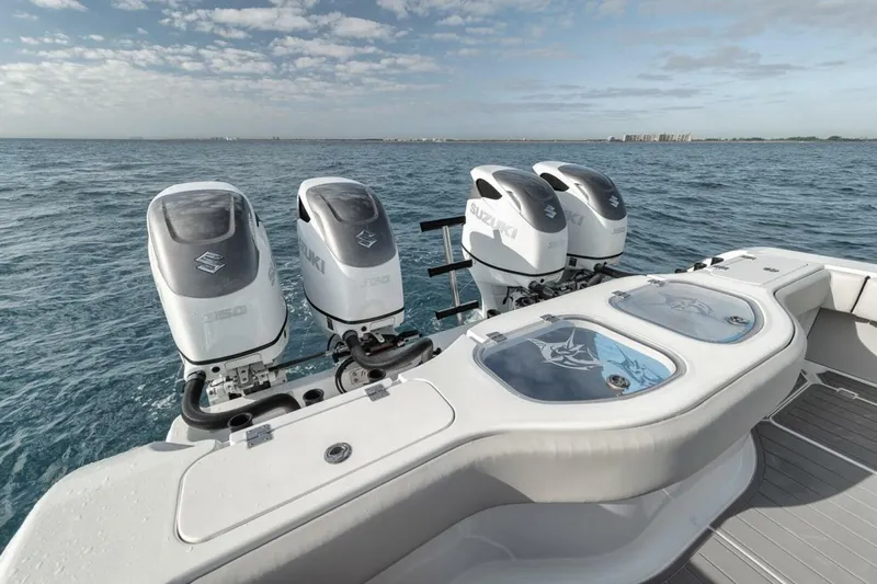 Slide: The Image of Four outboard motors on a 2019 Freeman 42LR boat, ocean backdrop. - 32