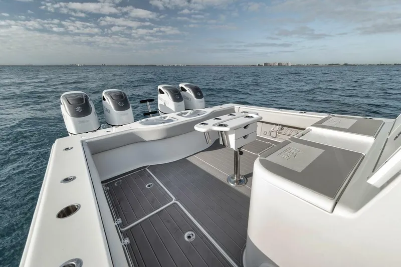 Slide: The Image of A 2019 Freeman 42LR boat with four engines on open water under a partly cloudy sky. - 33