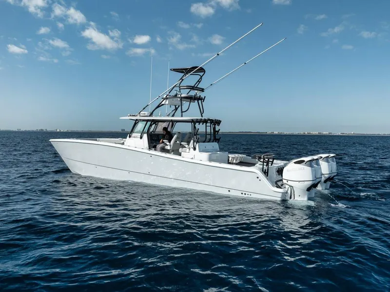 Slide: The Image of 2019 Freeman 42LR boat on open water under clear blue sky. - 42