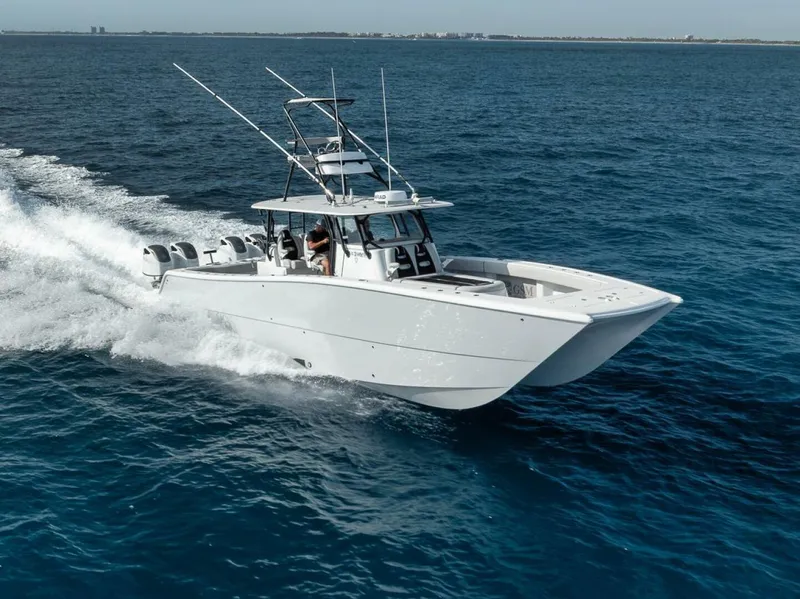 Slide: The Image of A 2019 Freeman 42LR boat cruising on open blue water. - 45