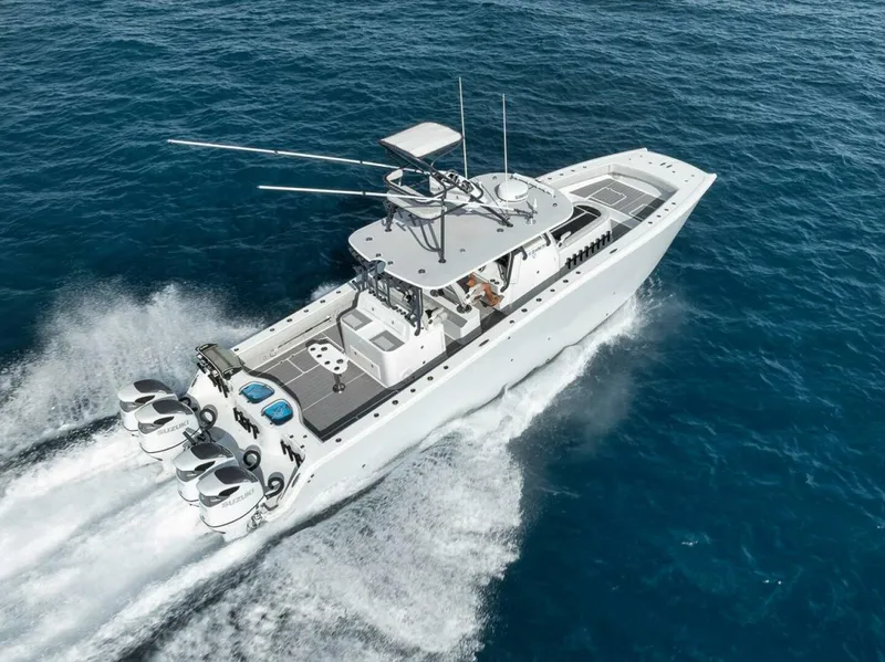 Slide: The Image of 2019 Freeman 42LR boat cruising on open water with four engines. - 46