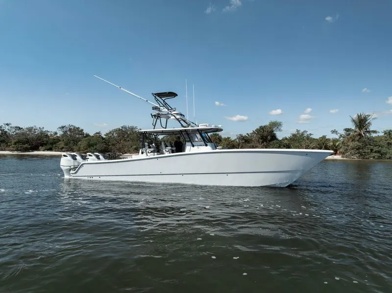 Slide: The Image of 2019 Freeman 42LR boat cruising on calm water under a clear blue sky. - 6