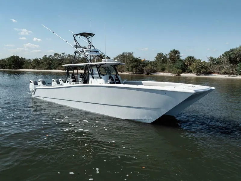 Slide: The Image of 2019 Freeman 42LR boat on calm water near a wooded shoreline. - 7