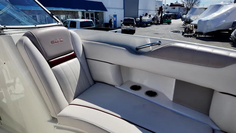 Slide: The Image of 2005 Sea Ray 270 Select EX boat interior with cushioned seating and cup holders. - 18