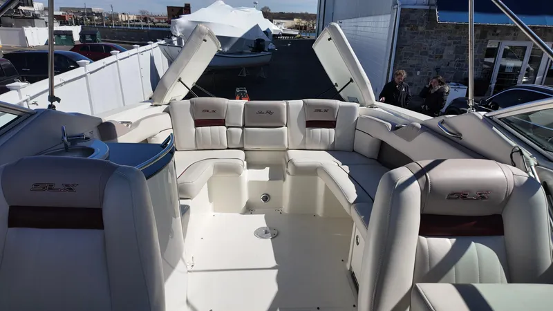 Slide: The Image of 2005 Sea Ray 270 Select EX boat interior with white seating and SLX branding. - 19