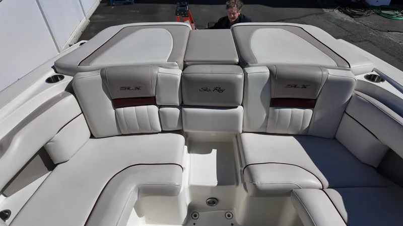 Slide: The Image of 2005 Sea Ray 270 Select EX boat interior with plush seating and cup holders. - 20