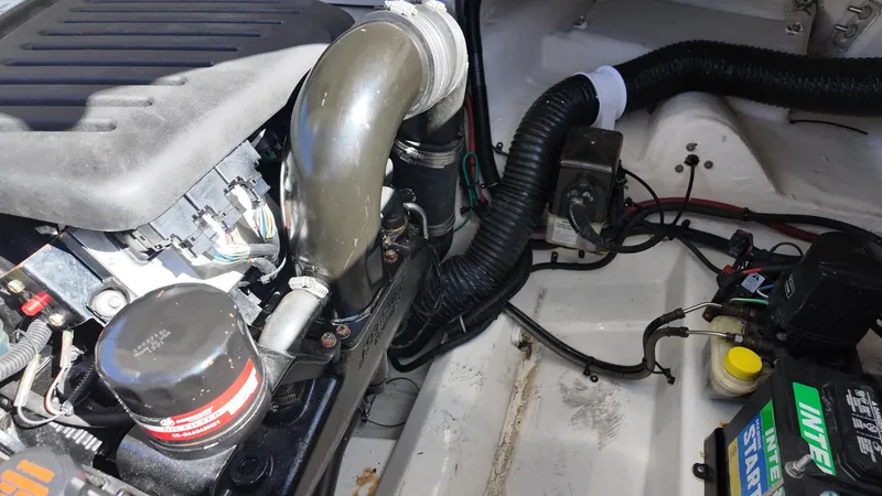 Slide: The Image of Engine compartment of a 2005 Sea Ray 270 Select EX boat, showing various components and wiring. - 26
