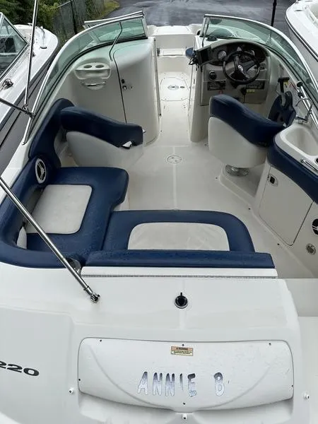 Slide: The Image of 2006 Sea Ray 220 Sundeck boat interior with blue and white seating. - 17