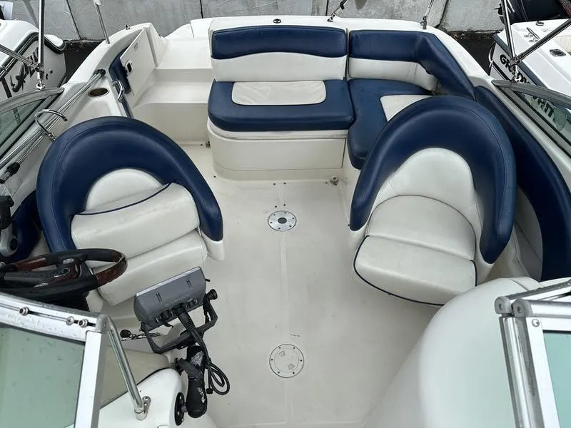 Slide: The Image of 2006 Sea Ray 220 Sundeck interior with blue and white seating arrangement. - 18