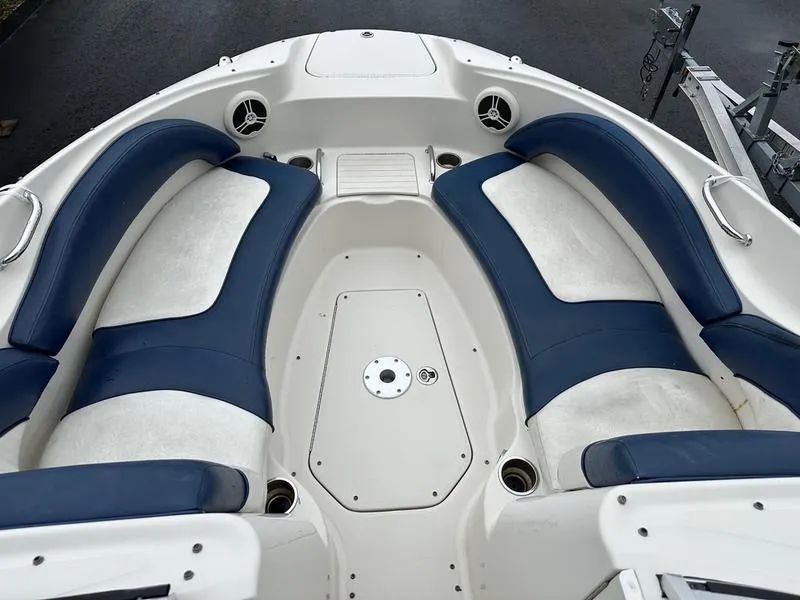 Slide: The Image of 2006 Sea Ray 220 Sundeck interior with blue and white seating arrangement. - 21