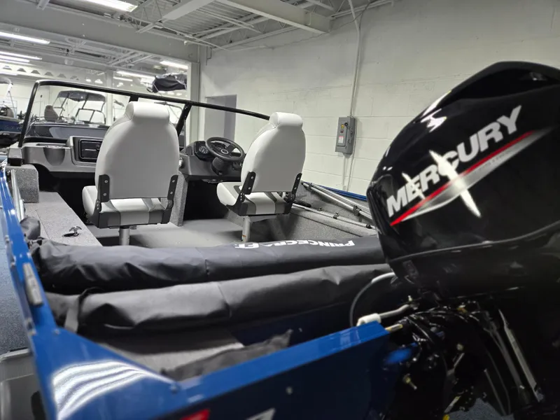 Slide: The Image of 2025 Princecraft Holiday 162 WS MAX boat interior with Mercury engine in showroom. - 3