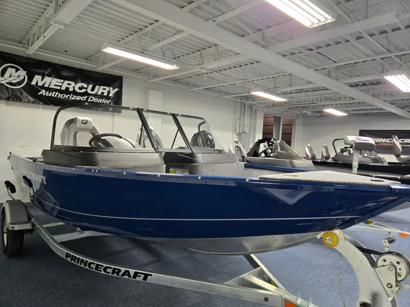 Slide: The Image of 2025 Princecraft Holiday 162 WS MAX boat displayed in showroom, blue exterior, on trailer. - 5