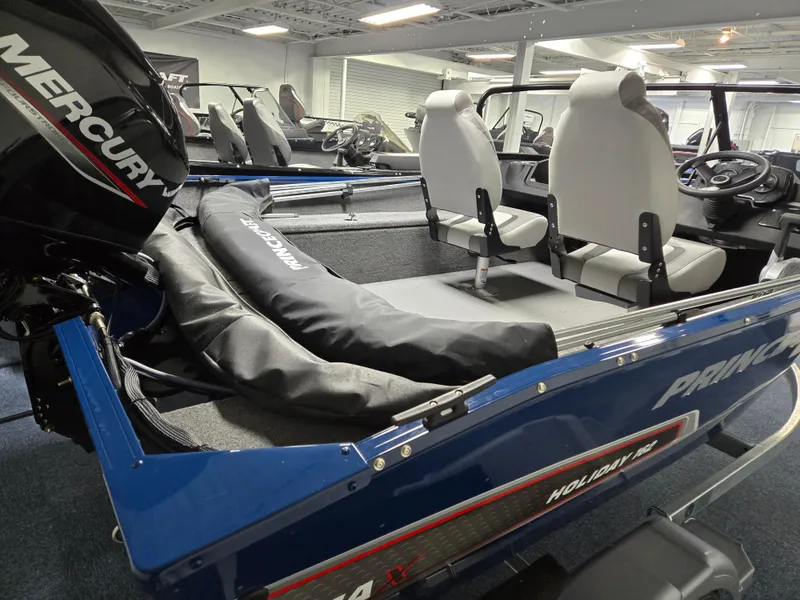 Slide: The Image of 2025 Princecraft Holiday 162 WS MAX boat interior with Mercury engine, showcasing seating and controls. - 7