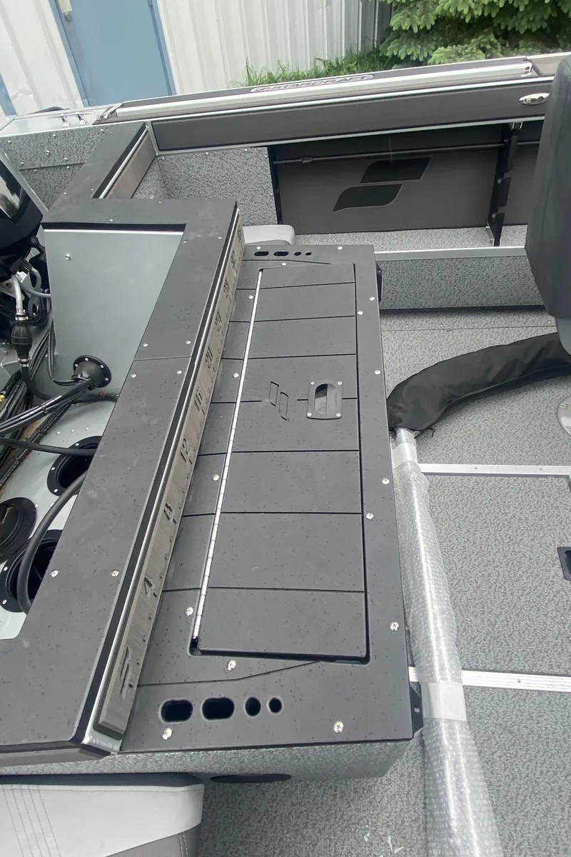 Slide: The Image of 2025 Starcraft Fishmaster 196 boat interior with storage compartments and seating. - 2