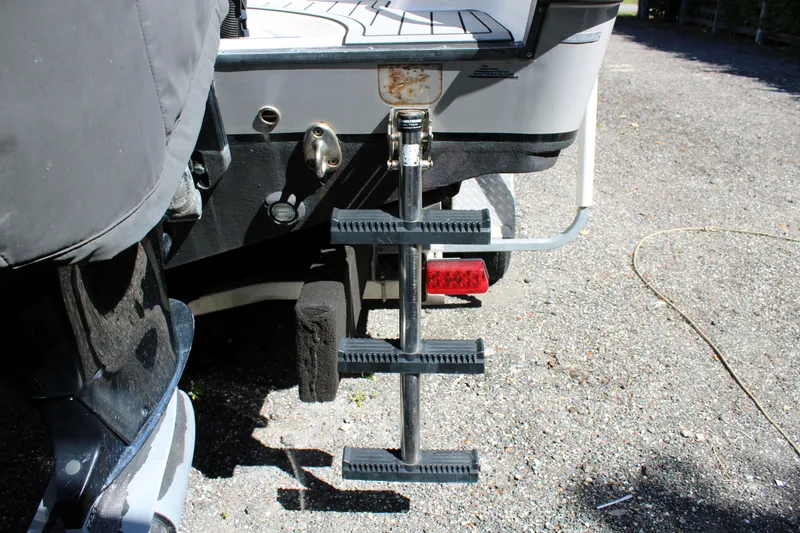 Slide: The Image of 2008 Edgewater 318CC boat ladder and motor detail on a sunny day. - 10