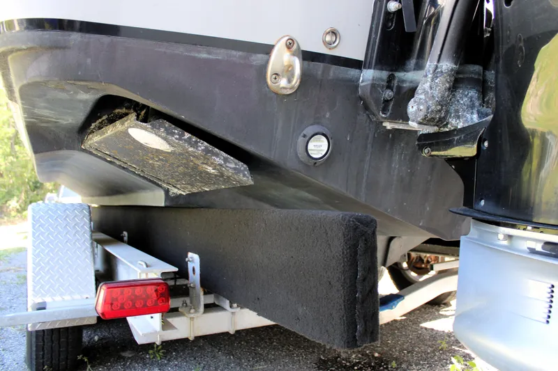 Slide: The Image of 2008 Edgewater 318CC boat on trailer, showing hull and propeller details. - 11