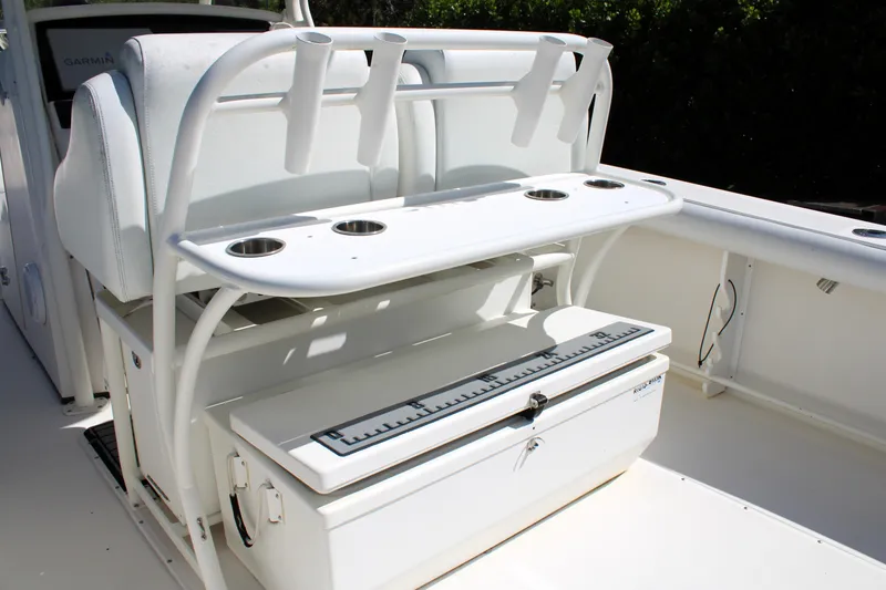 Slide: The Image of 2008 Edgewater 318CC boat interior with rod holders and storage compartment. - 18