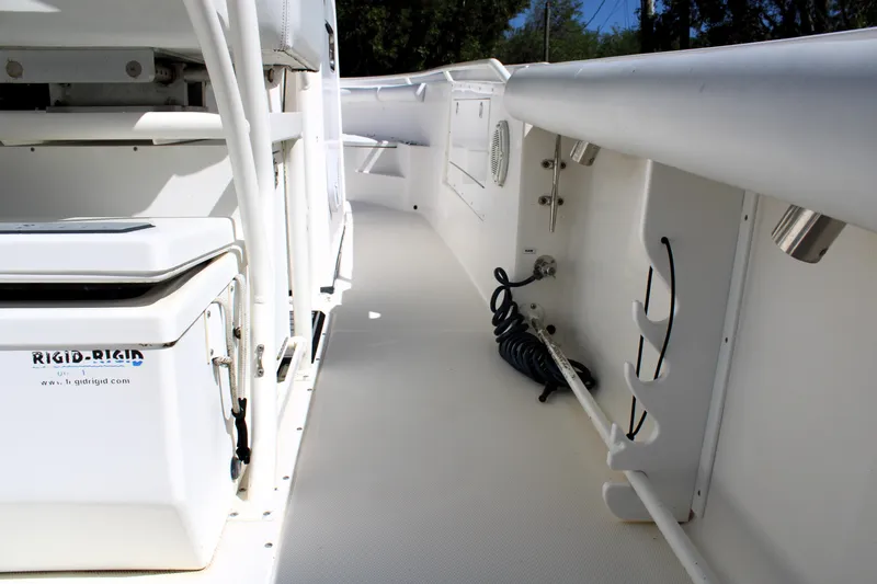 Slide: The Image of 2008 Edgewater 318CC boat interior with storage compartments and coiled cable. - 19