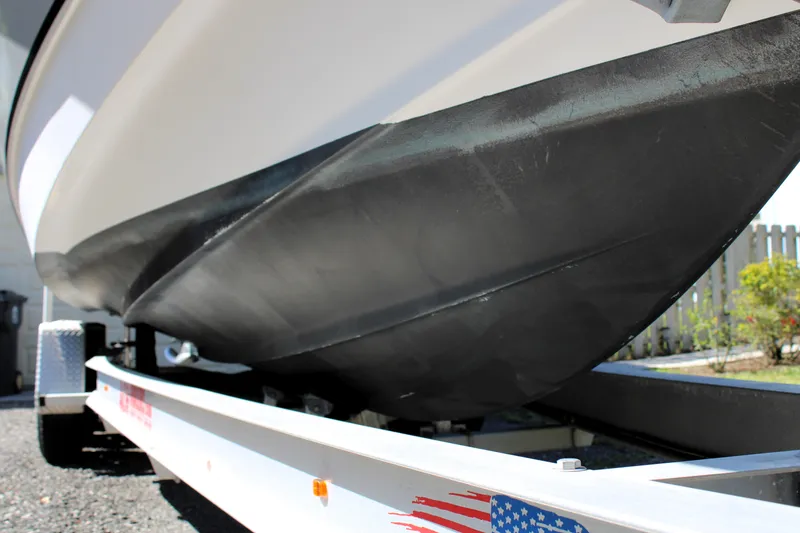 Slide: The Image of 2008 Edgewater 318CC boat hull on trailer, close-up view. - 2