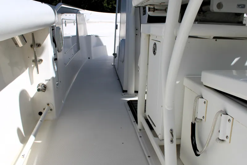 Slide: The Image of 2008 Edgewater 318CC boat interior, featuring sleek white design and spacious deck layout. - 20